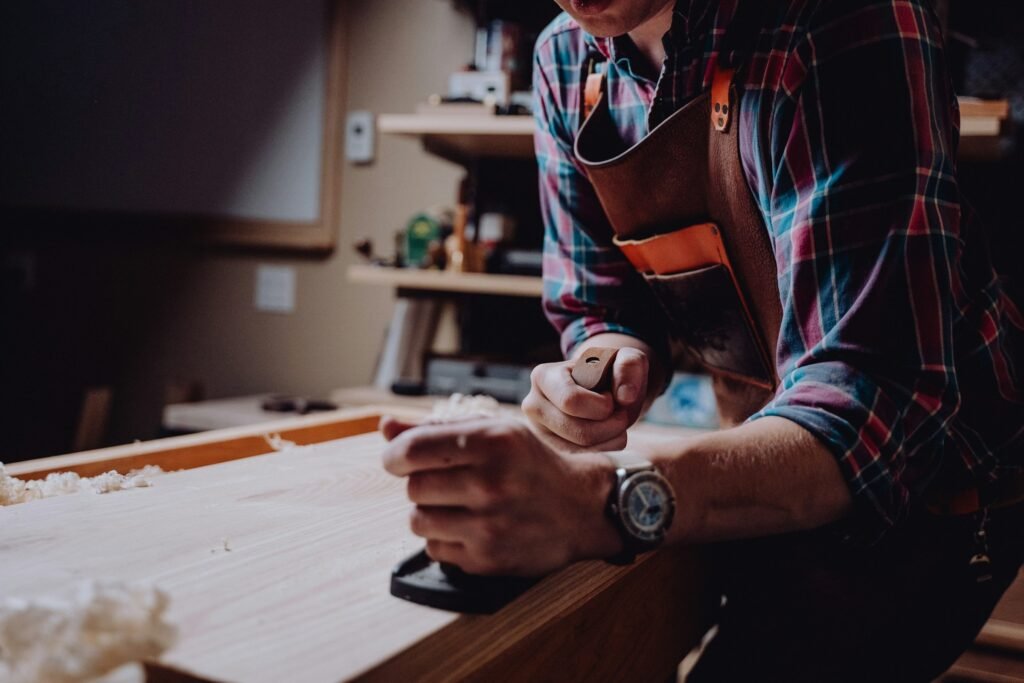 Skilled carpenter assembling modular furniture components and fitting hardware